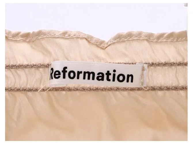 Top fruncido con volantes en seda color marfil Viviana de Reformation Blanco Crudo 